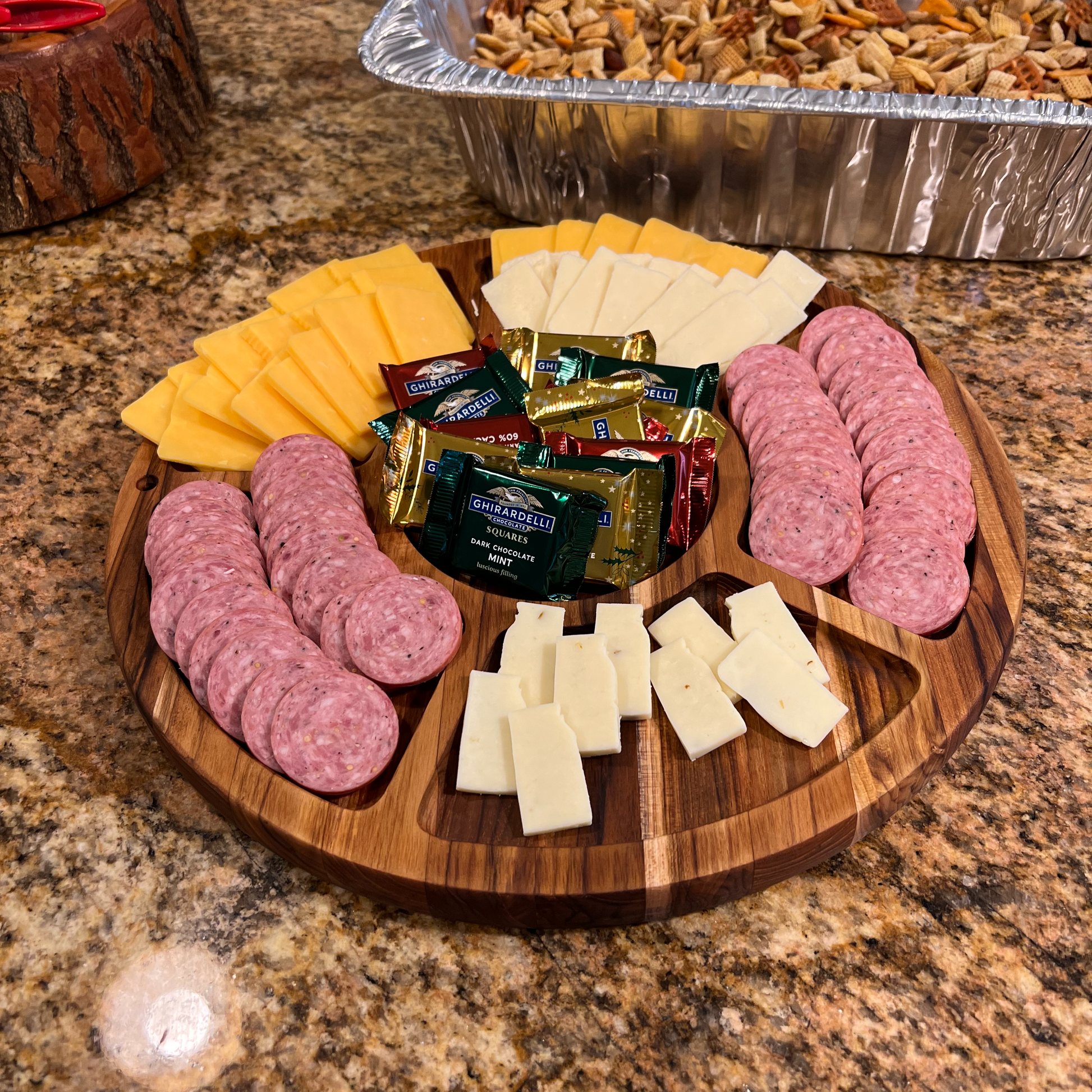 a wooden plate topped with meat and cheese