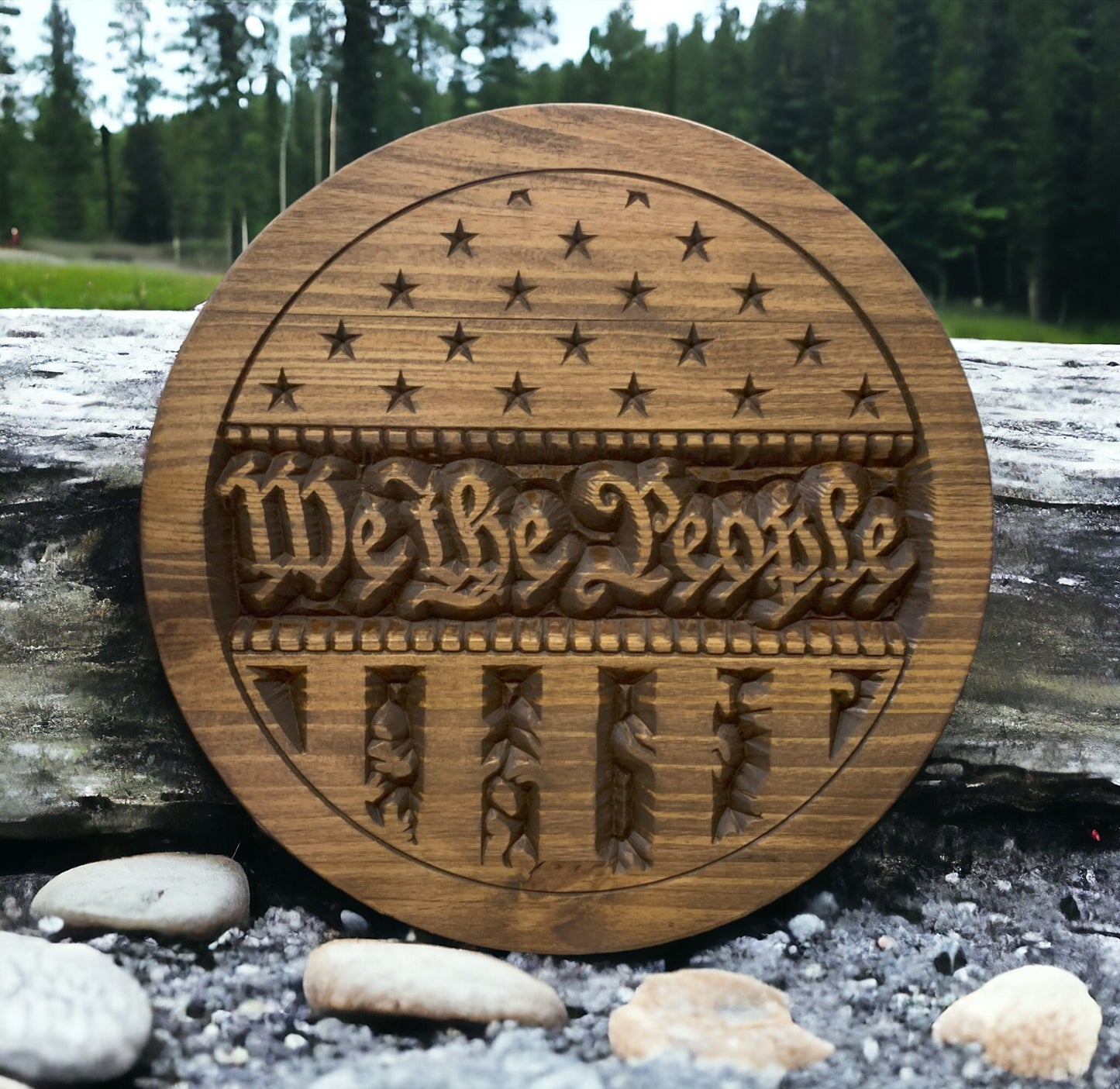 a wooden sign sitting on top of a pile of rocks