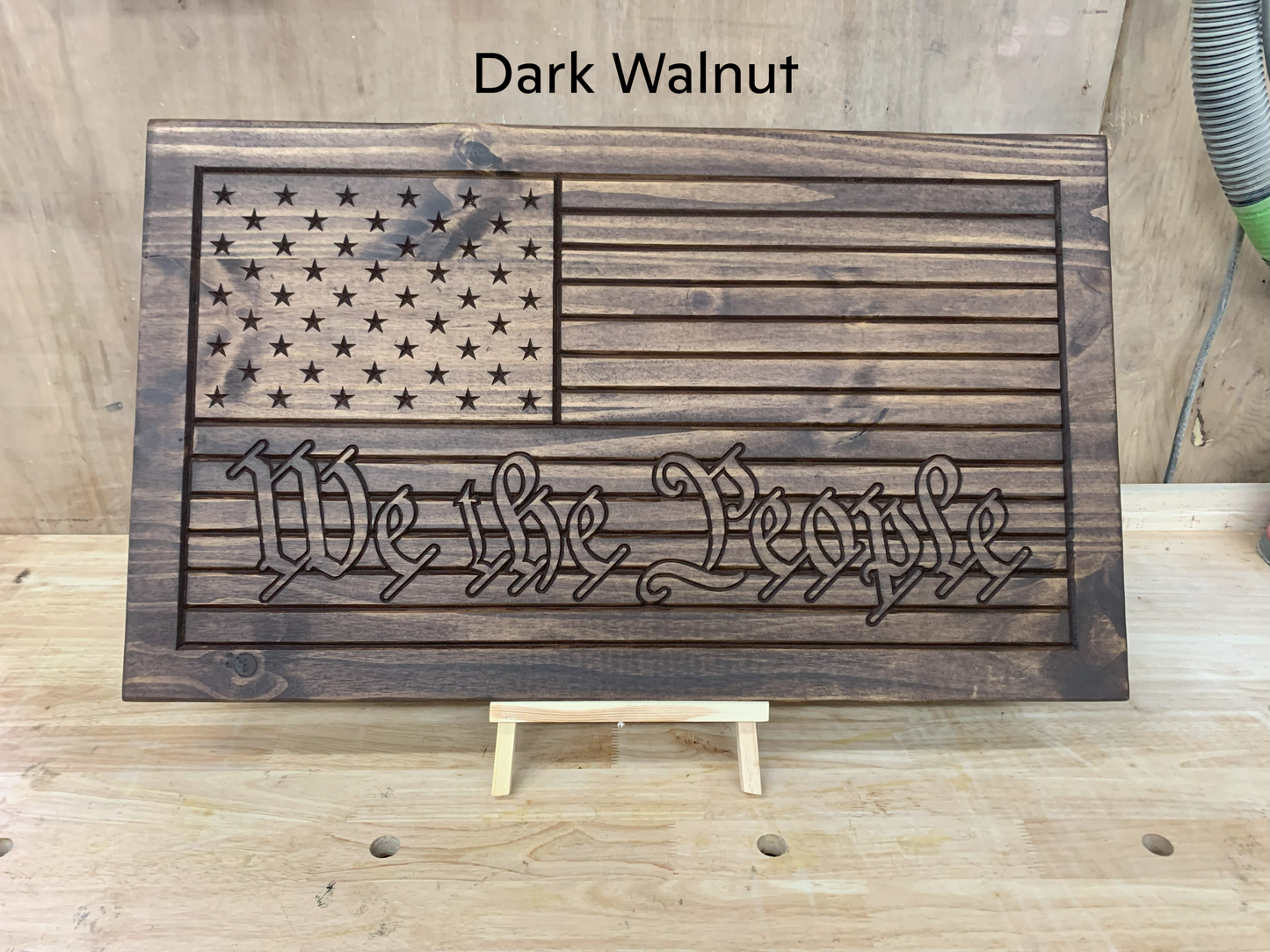 a wooden sign with the words we the people on it